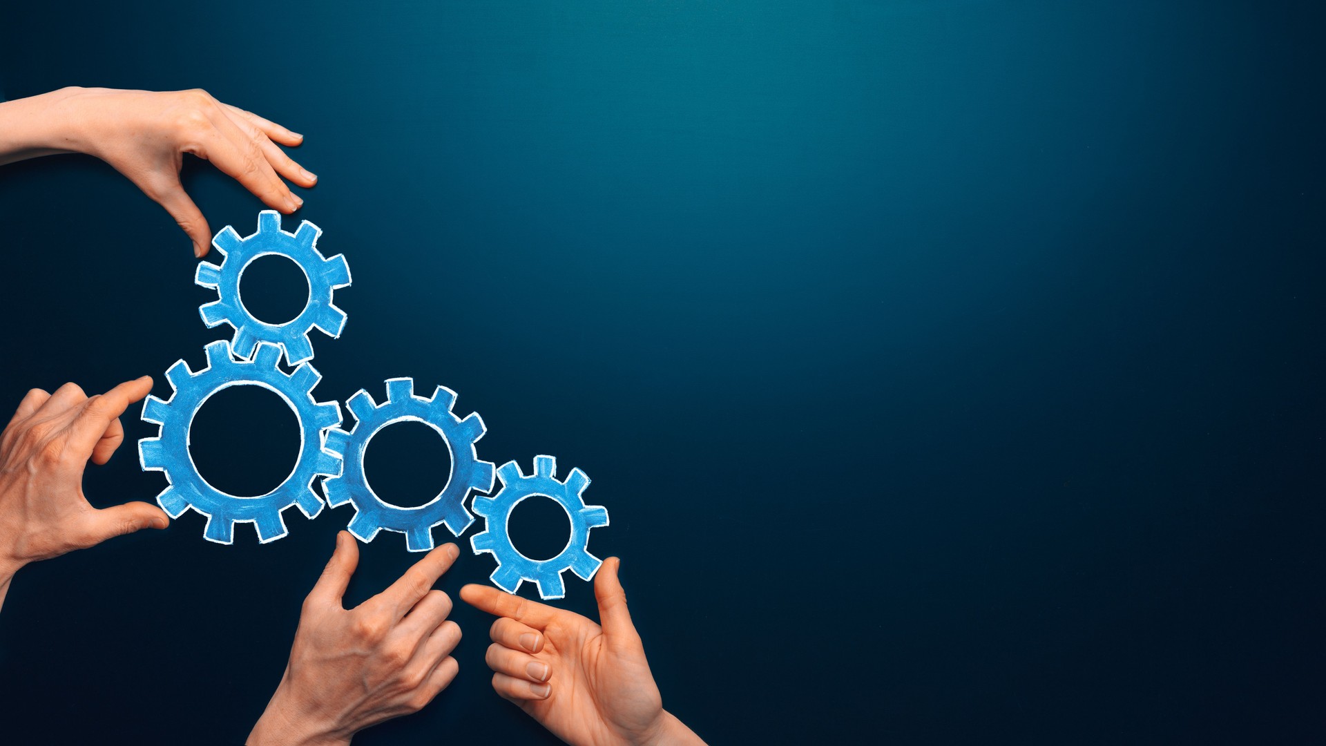 Teamwork concept. team connects gear parts. Idea of partnership, cooperation, team work. Metaphor for joining a partnership as diverse gears connected together as a corporate symbol for cooperation and working collaboration. Copy space